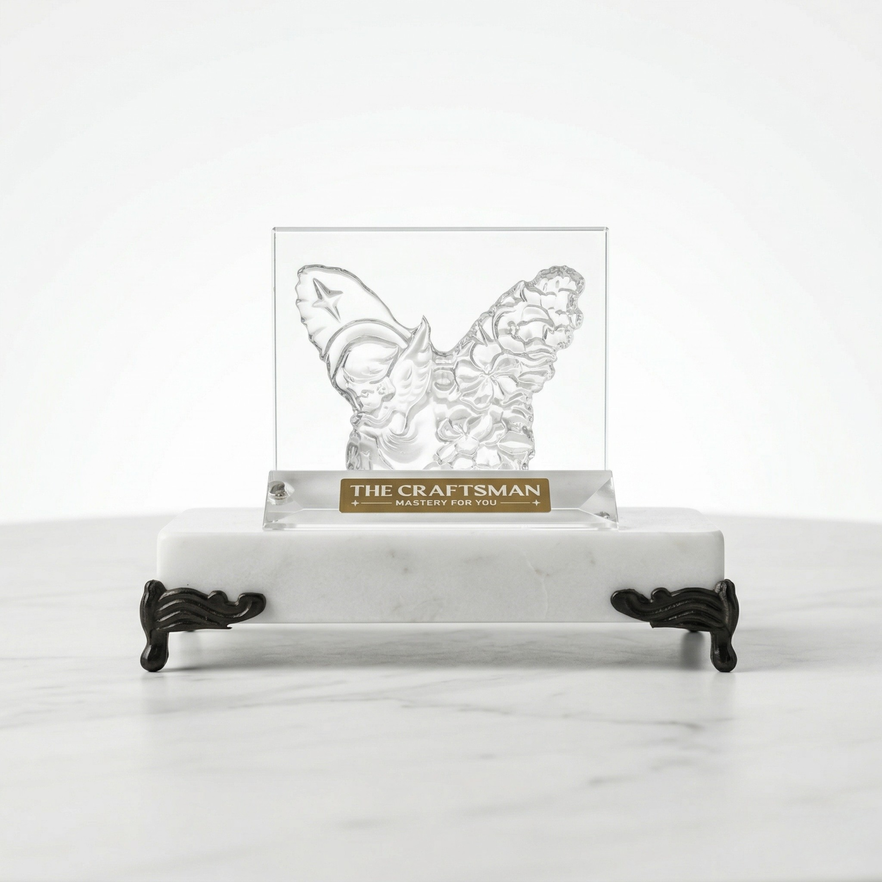 Butterfly-shaped crystal on a marble stand with 'The Craftsman' branding.
