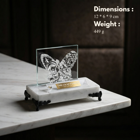 Glass butterfly sculpture on a marble base with dimensions and weight information displayed.