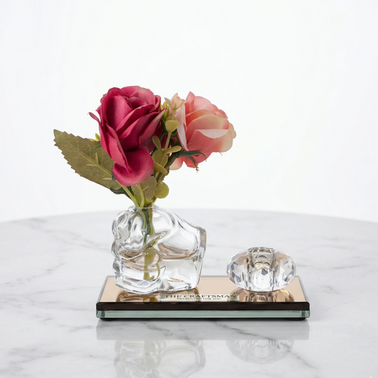 Clear glass vase with pink flowers on a marble surface