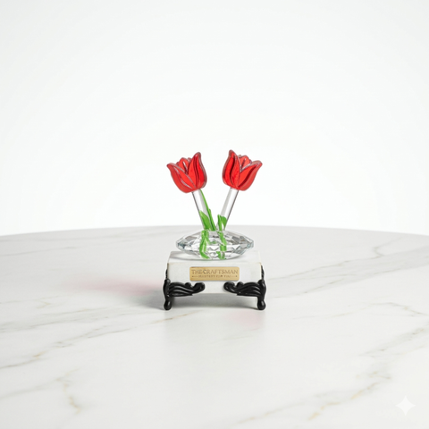 Marble base paper weight with two crystal tulip flowers with round clear glass stem growing from the marble with traditional legs