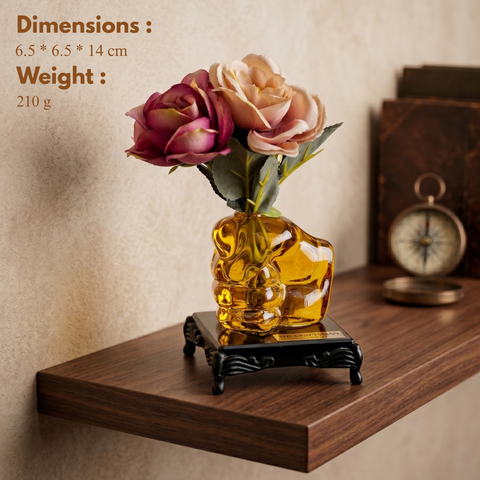 Glass human fist shaped flower vase paperweight placed on black glass base with traditional foots