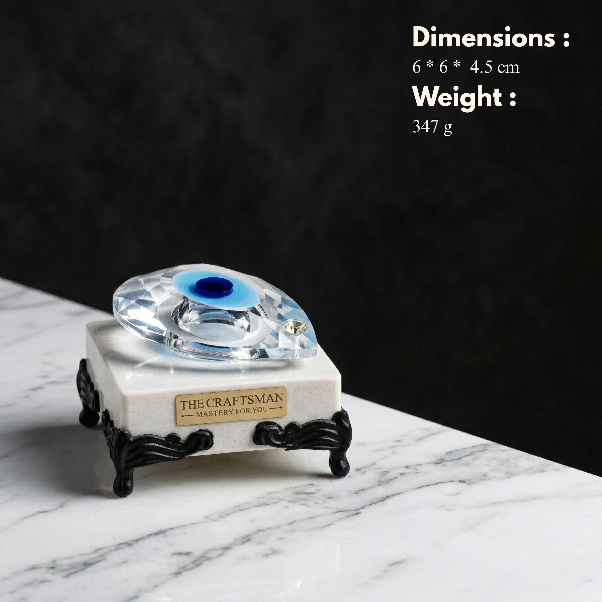 Evil eye crystal aura paperweight lifestyle shot on marble base by The Craftsman