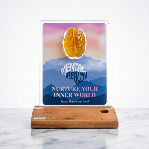 Decorative wooden art piece with crystal brain set against a backdrop of mental health motivational text on a wooden stand.
