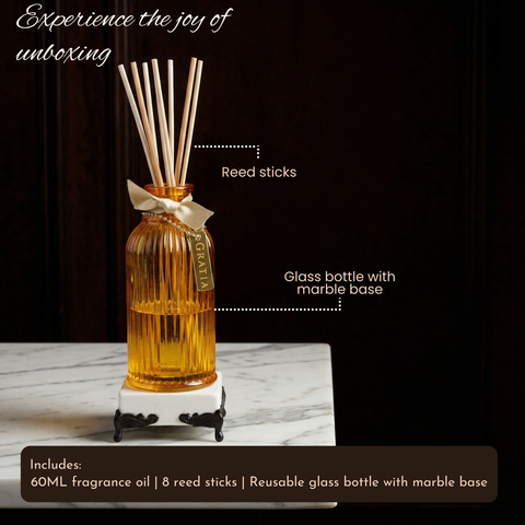 Reed diffuser with marble base on a dark background