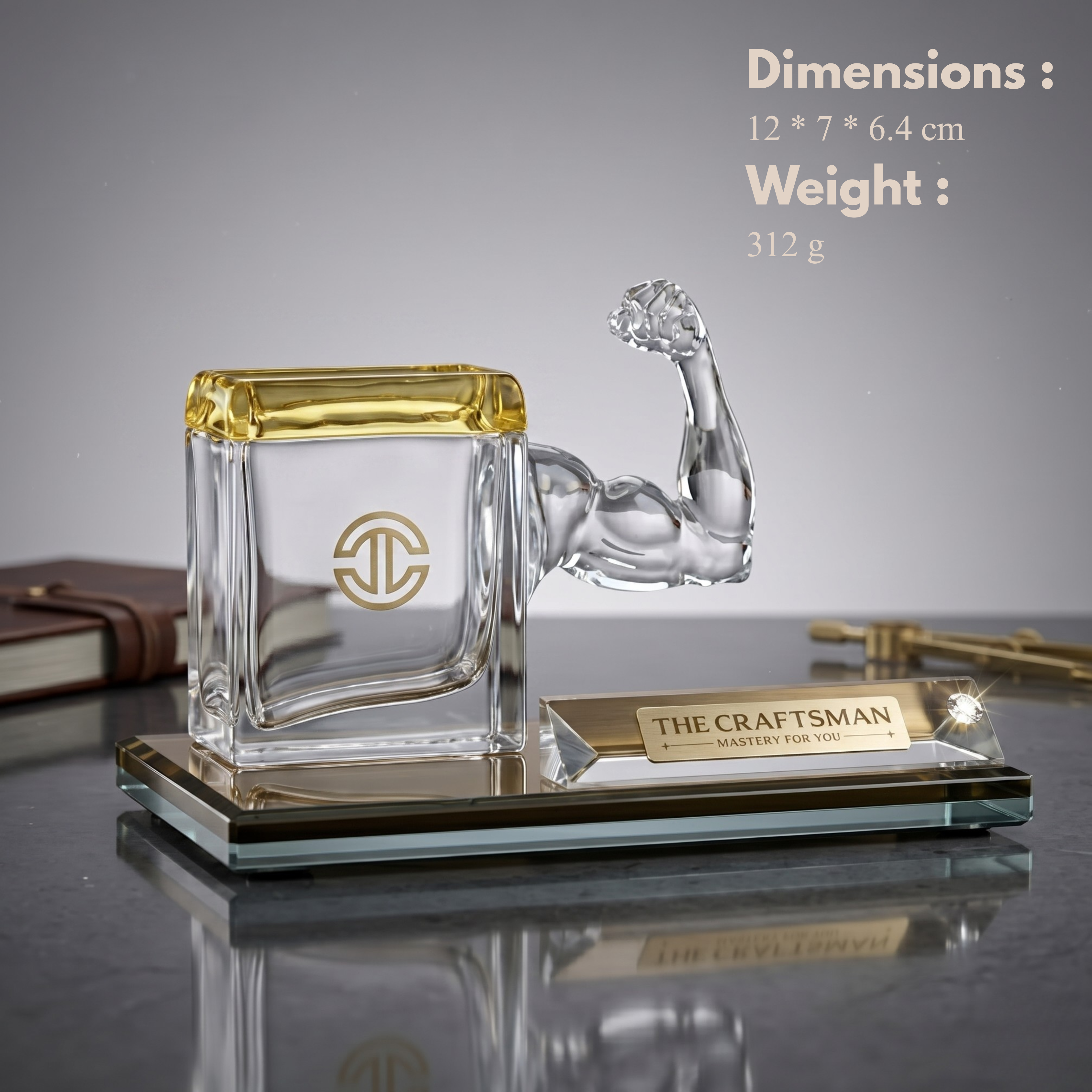 Glass pen stand with arm sculpture placed on a glass base, featuring 'The Craftsman' branding.